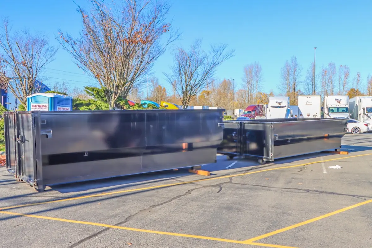 Professional dumpster rental service with roll-off container on residential driveway in Creston
